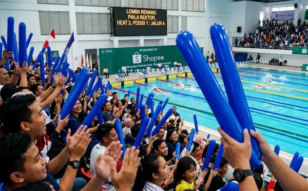 Balon tepuk Grobogan digunakan penonton untuk memeriahkan acara lomba renang di dalam gedung olahraga.
