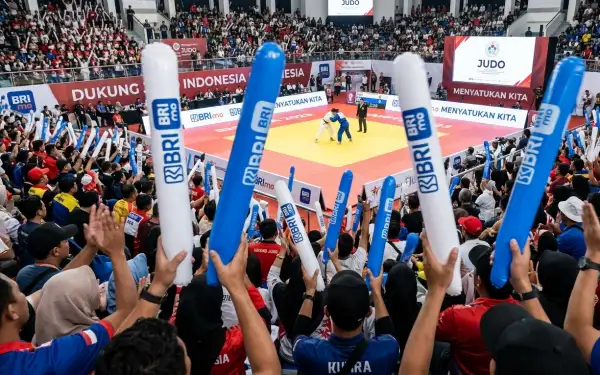 Penonton mengangkat Balon Tepuk Murung Raya untuk memberikan dukungan kepada atlet pada pertandingan jud