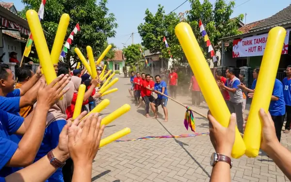 Peserta lomba tarik tambang mendapat dukungan penonton dengan Balon Tepuk Pulang Pisau berwarna kuning.